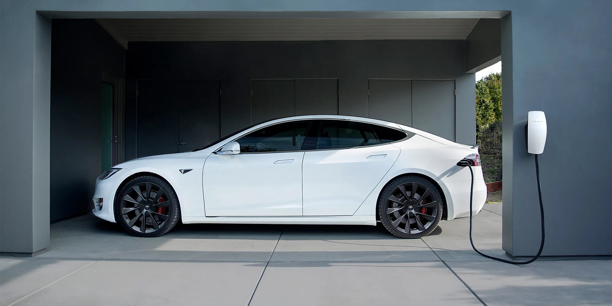 Tesla charging in a garage