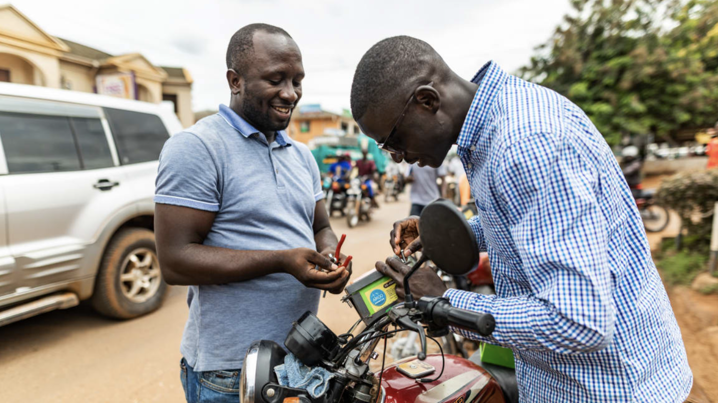 Two people working on battery