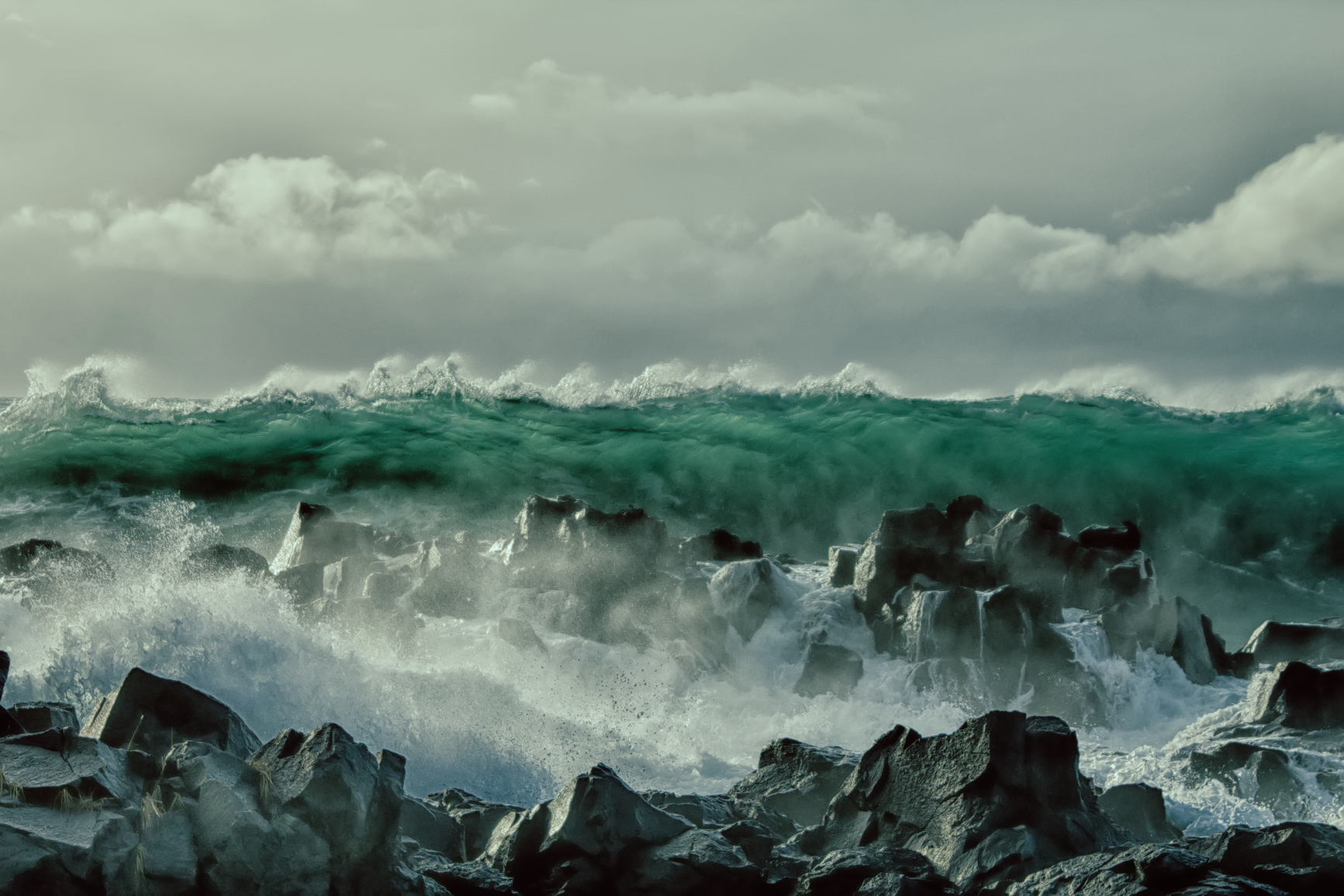 Huge wave crashing into rocks