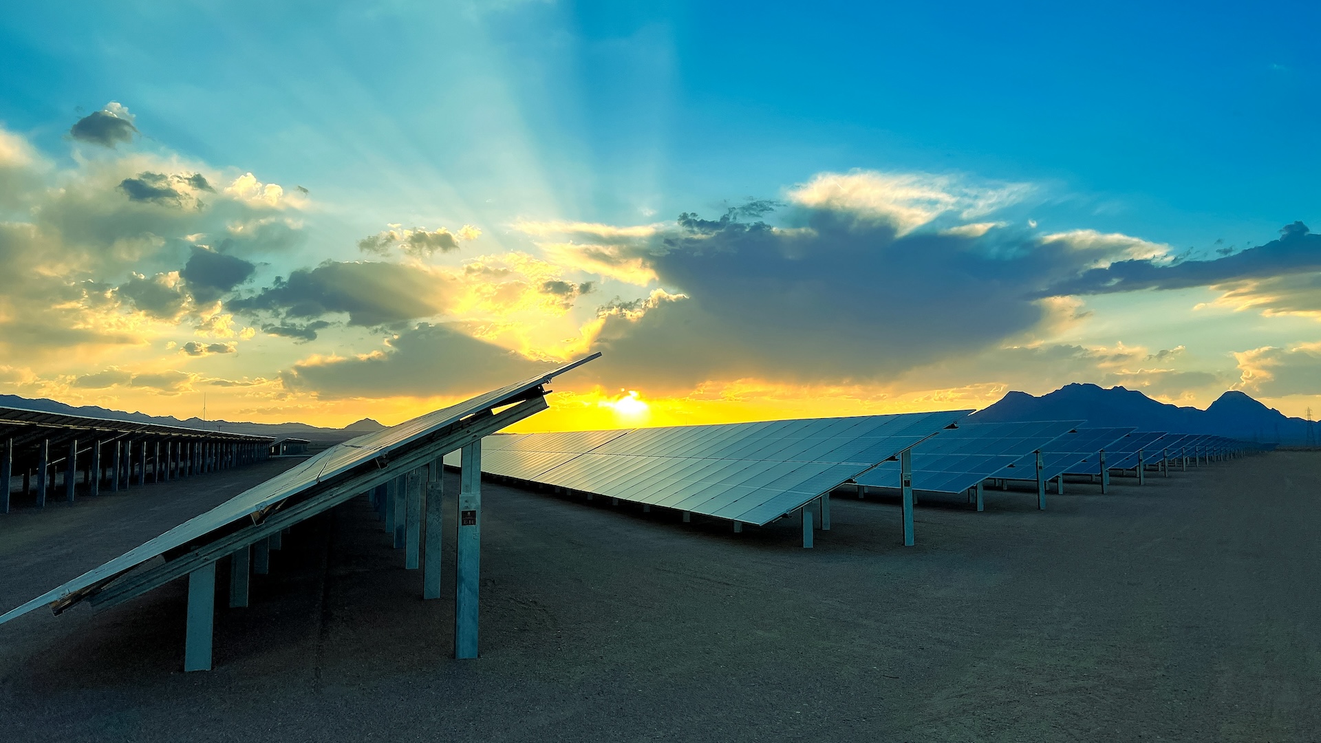 Solar panels with a sunrise and blue sky